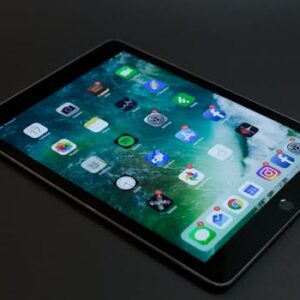 A sleek tablet with various multimedia and social media app icons on display.