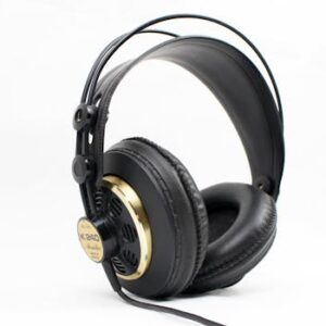 High-quality black and gold studio headphones with thick padding on a white background, ideal for music professionals.